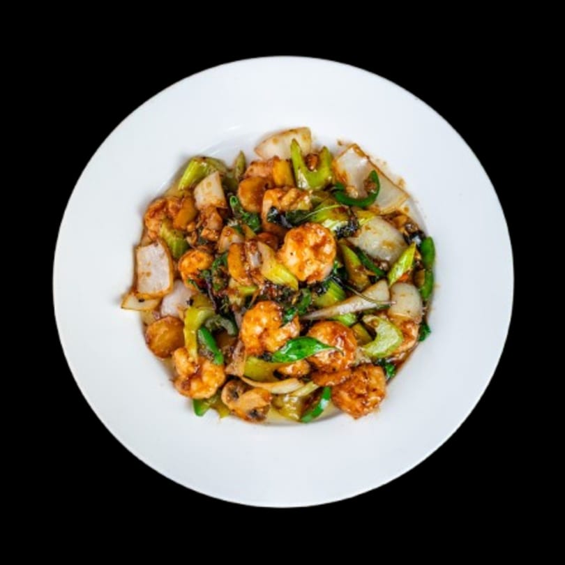 Canton Bistro's stir-fried shrimp with green peppers, onions, and mushrooms on a white plate.