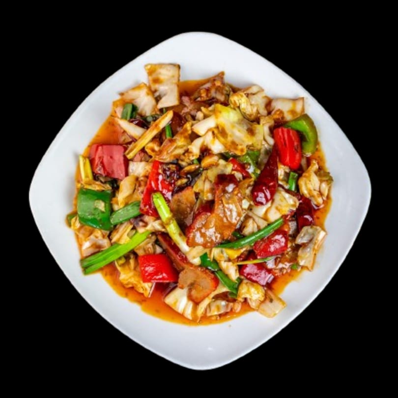 Canton Bistro's spicy stir-fried pork with cabbage, bell peppers, and scallions in a rich sauce.