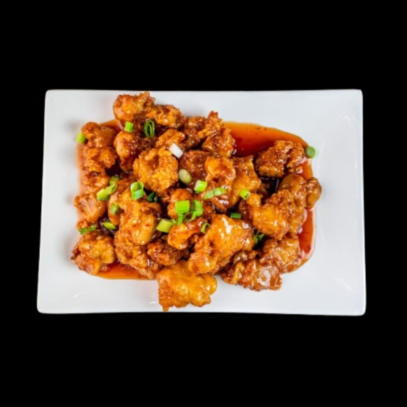 Canton Bistro's General Tso's chicken, a plate of crispy fried chicken pieces coated in a sweet and spicy sauce.